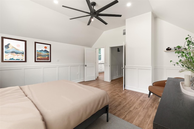 189 Blue Creek Rd, Heron, MT 59844 - bedroom with light wood-type flooring, lofted ceiling, a wainscoted wall, a decorative wall, and a ceiling fan