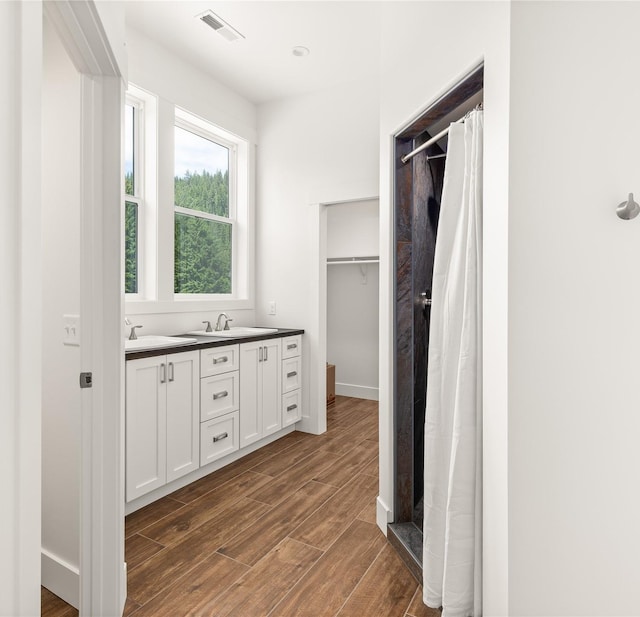 189 Blue Creek Rd, Heron, MT 59844 - full bathroom with wood finished floors, a shower with curtain, double vanity, and a spacious closet