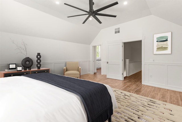 189 Blue Creek Rd, Heron, MT 59844 - bedroom with light wood-style flooring, lofted ceiling, a wainscoted wall, a decorative wall, and a ceiling fan