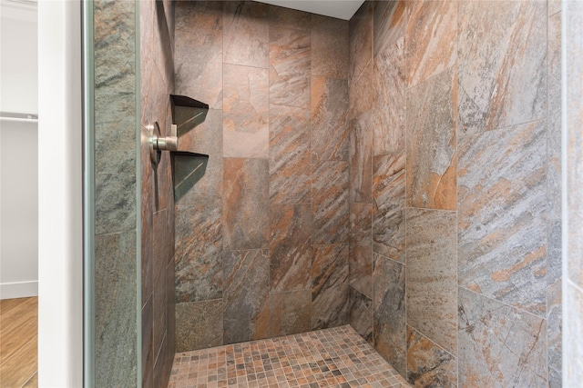 189 Blue Creek Rd, Heron, MT 59844 - bathroom featuring a tile shower and wood finished floors