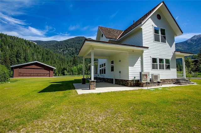 189 Blue Creek Rd, Heron, MT 59844 - back of house with a mountain view, a yard, and a wooded view