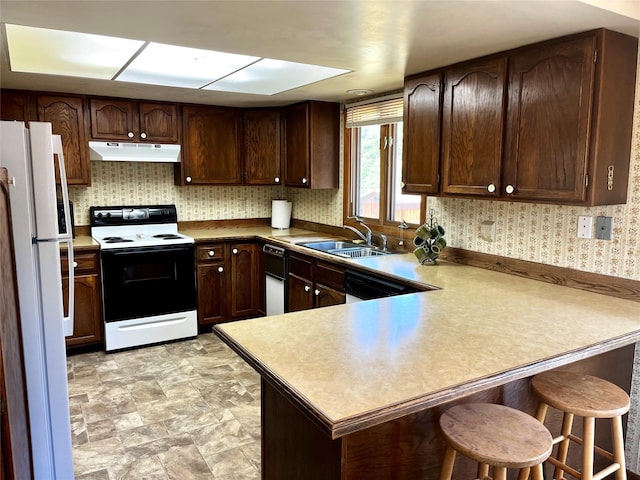 1114 Creek Crossing Rd, Missoula, MT 59802 - kitchen featuring electric range, freestanding refrigerator, a sink, under cabinet range hood, and a peninsula