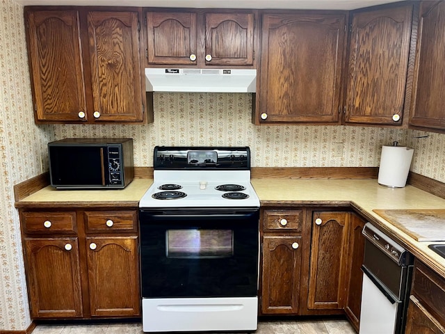 1114 Creek Crossing Rd, Missoula, MT 59802 - kitchen featuring electric stove, under cabinet range hood, black microwave, wallpapered walls, and light countertops