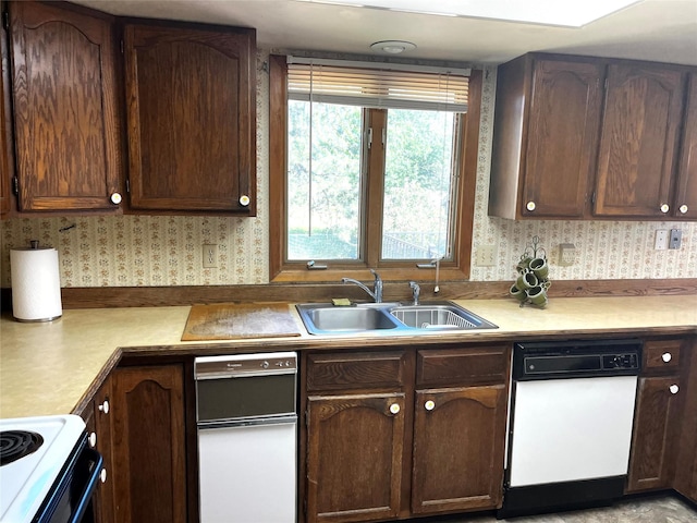1114 Creek Crossing Rd, Missoula, MT 59802 - kitchen with a sink, white dishwasher, wallpapered walls, light countertops, and dark brown cabinets