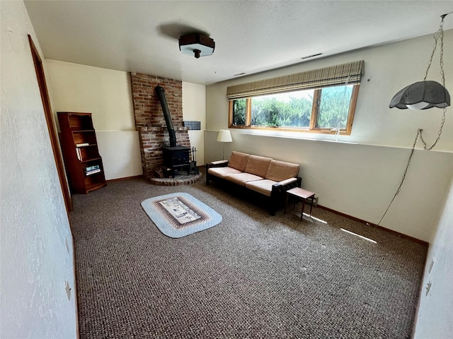 1114 Creek Crossing Rd, Missoula, MT 59802 - living area featuring a wood stove, carpet flooring, and baseboards