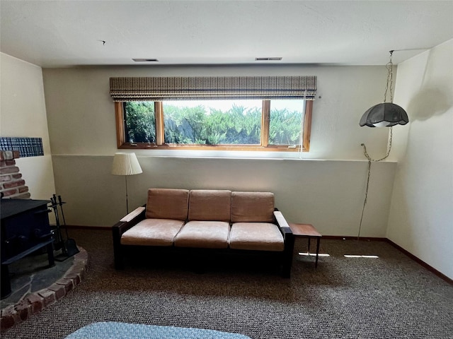1114 Creek Crossing Rd, Missoula, MT 59802 - carpeted living area with a wood stove and baseboards