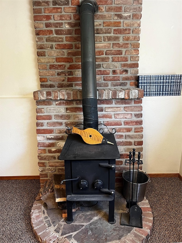 1114 Creek Crossing Rd, Missoula, MT 59802 - detailed view of a wood stove, carpet flooring, and baseboards