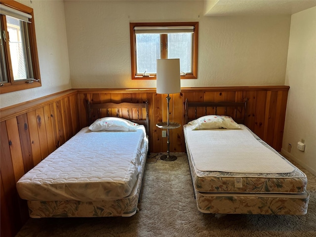 1114 Creek Crossing Rd, Missoula, MT 59802 - carpeted bedroom with multiple windows, wood walls, and wainscoting