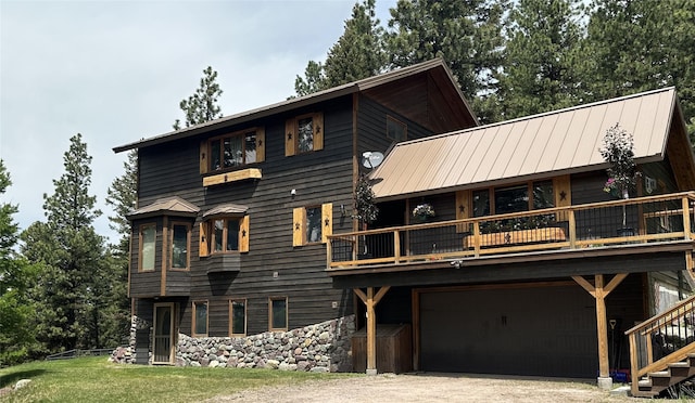 340 Elkhorn Rd, Seeley Lake, MT 59868 - back of property featuring a garage, dirt driveway, a standing seam roof, and metal roof