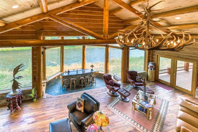 6900 Nez Perce Rd, Darby, MT 59829 - sunroom with french doors, a chandelier, a water view, and healthy amount of natural light