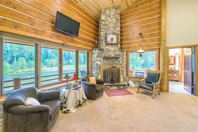 6900 Nez Perce Rd, Darby, MT 59829 - living room featuring wood ceiling, carpet floors, high vaulted ceiling, a stone fireplace, and wooden walls