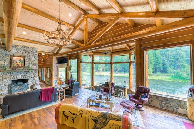 6900 Nez Perce Rd, Darby, MT 59829 - living area with a chandelier, wood ceiling with exposed beams, wood-type flooring, plenty of natural light, and high vaulted ceiling