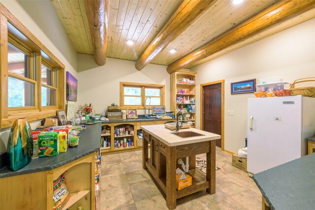6900 Nez Perce Rd, Darby, MT 59829 - kitchen featuring open shelves, a sink, freestanding refrigerator, recessed lighting, and wood ceiling with exposed beams
