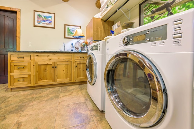 6900 Nez Perce Rd, Darby, MT 59829 - washroom with cabinet space, washing machine and clothes dryer, and light tile patterned floors