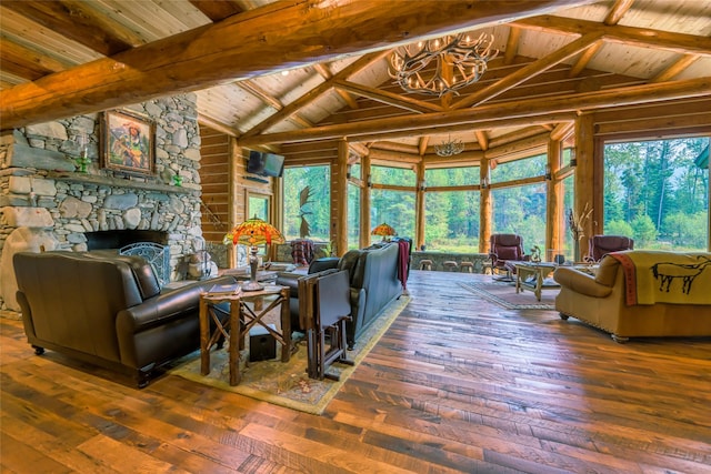 6900 Nez Perce Rd, Darby, MT 59829 - living area with a chandelier, wood ceiling, wood-type flooring, and a fireplace