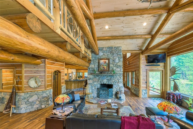 6900 Nez Perce Rd, Darby, MT 59829 - living room with wooden ceiling with exposed beams, hardwood / wood-style floors, a stone fireplace, and arched walkways