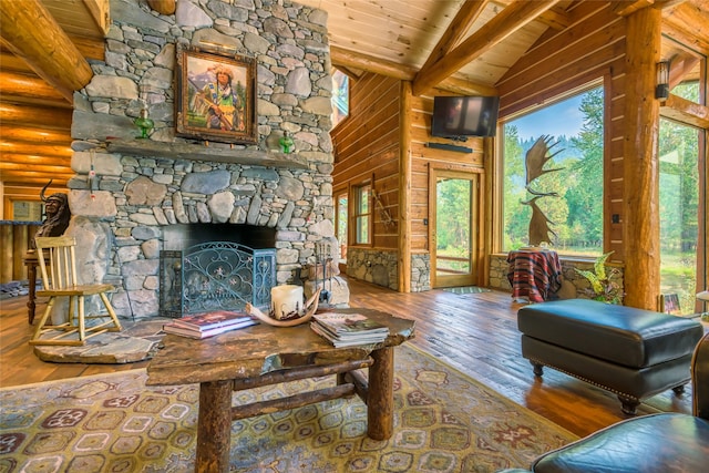 6900 Nez Perce Rd, Darby, MT 59829 - living area featuring wood-type flooring, wood ceiling with exposed beams, a stone fireplace, and high vaulted ceiling