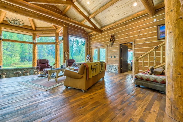 6900 Nez Perce Rd, Darby, MT 59829 - living room with wood ceiling with exposed beams, hardwood / wood-style floors, stairway, healthy amount of natural light, and wooden walls