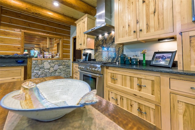 6900 Nez Perce Rd, Darby, MT 59829 - kitchen featuring wall chimney exhaust hood, high end stove, dark countertops, light brown cabinetry, and recessed lighting