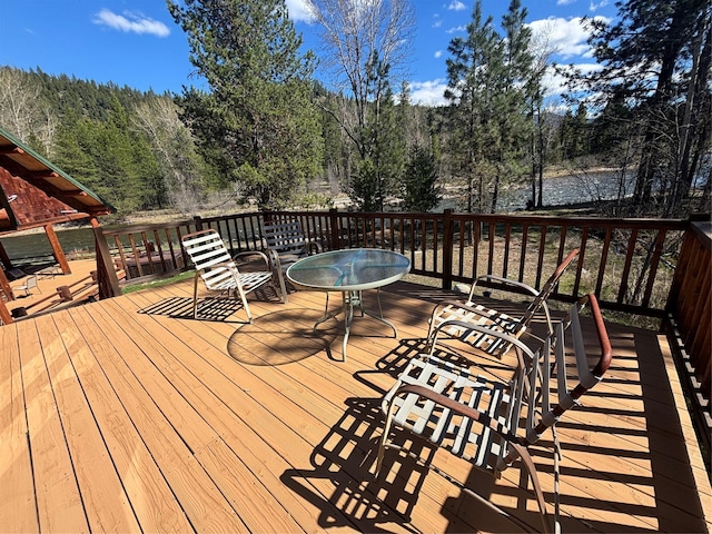 6900 Nez Perce Rd, Darby, MT 59829 - wooden deck featuring a wooded view and a water view