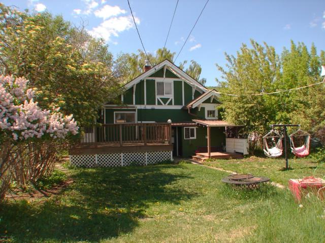 808 W 4th St, Anaconda, MT 59711 - back of house featuring a fire pit, a lawn, and a deck