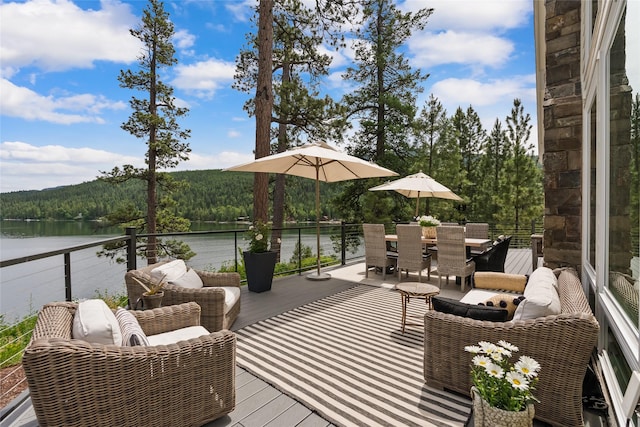 14833 Sunburst Dr, Bigfork, MT 59911 - wooden terrace with a water view, a wooded view, and outdoor dining space