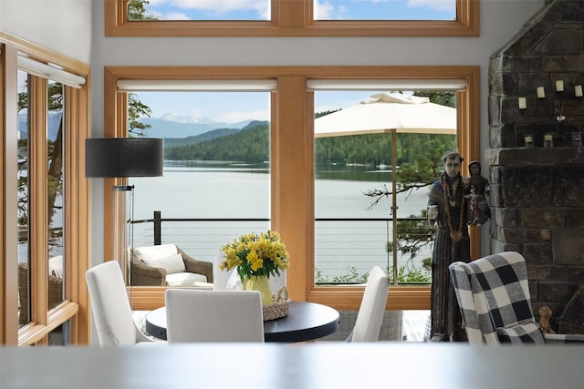 14833 Sunburst Dr, Bigfork, MT 59911 - dining room featuring healthy amount of natural light and a water and mountain view
