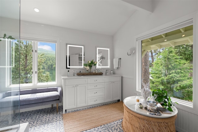 14833 Sunburst Dr, Bigfork, MT 59911 - full bath featuring double vanity, a freestanding tub, and plenty of natural light