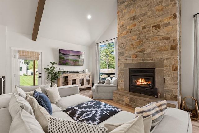 14833 Sunburst Dr, Bigfork, MT 59911 - living area with wood finished floors, healthy amount of natural light, a fireplace, and high vaulted ceiling