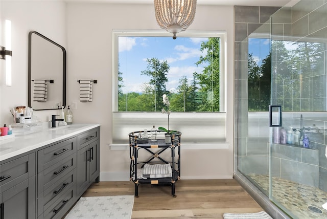 14833 Sunburst Dr, Bigfork, MT 59911 - bathroom featuring vanity, wood finished floors, and a stall shower