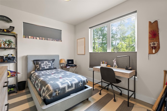 14833 Sunburst Dr, Bigfork, MT 59911 - bedroom featuring an office area and wood finished floors