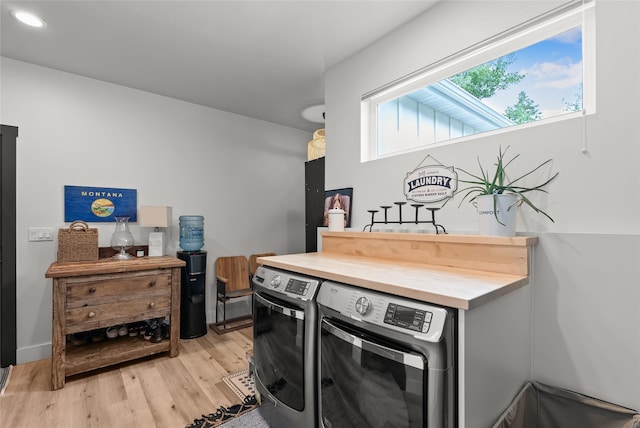 14833 Sunburst Dr, Bigfork, MT 59911 - laundry room with independent washer and dryer, light wood-style floors, and recessed lighting
