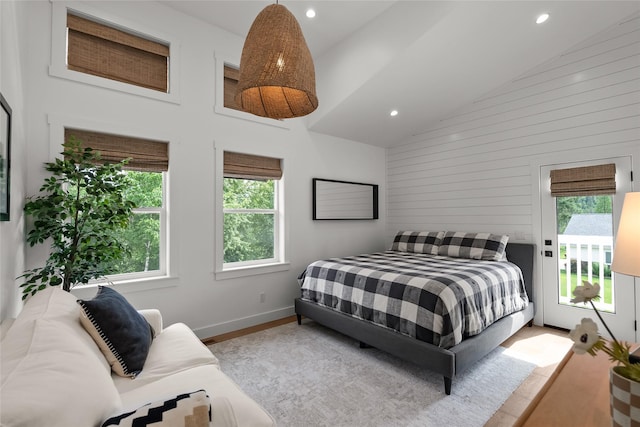 14833 Sunburst Dr, Bigfork, MT 59911 - bedroom featuring high vaulted ceiling, access to exterior, wood finished floors, recessed lighting, and wooden walls