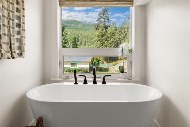 14833 Sunburst Dr, Bigfork, MT 59911 - full bath with a freestanding tub and plenty of natural light