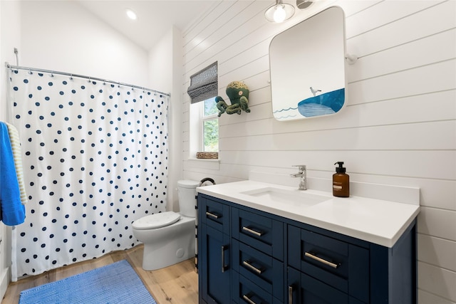 14833 Sunburst Dr, Bigfork, MT 59911 - bathroom featuring wood finished floors, vanity, curtained shower, wood walls, and vaulted ceiling