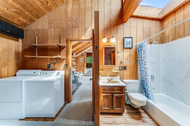 9230 Mt Highway 35, Bigfork, MT 59911 - full bathroom with washer and dryer, lofted ceiling, vanity, wood walls, and wooden ceiling