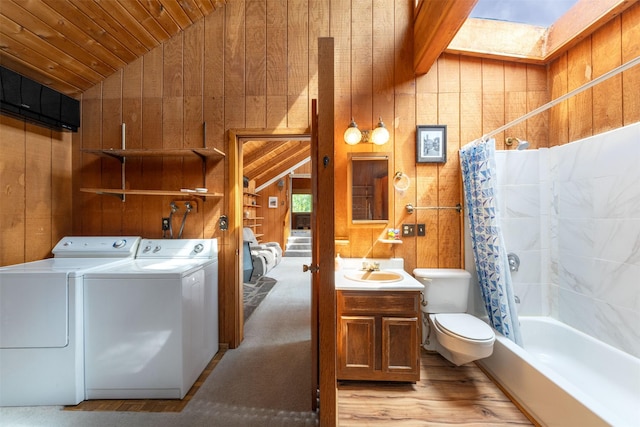 9230 Mt Highway 35, Bigfork, MT 59911 - laundry area with separate washer and dryer, wooden walls, wooden ceiling, and light wood finished floors