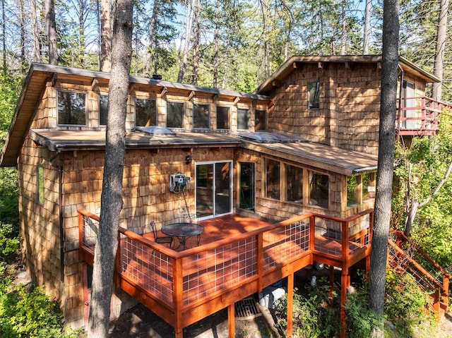 9230 Mt Highway 35, Bigfork, MT 59911 - back of property with a wooden deck and view of wooded area