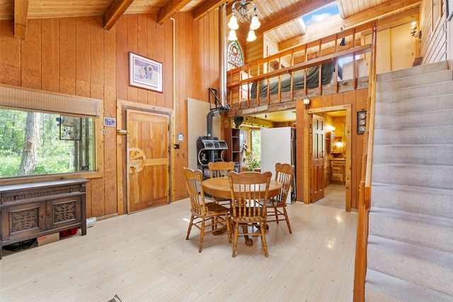 9230 Mt Highway 35, Bigfork, MT 59911 - dining area with wooden walls, stairway, healthy amount of natural light, a wooden ceiling with exposed beams, and high vaulted ceiling