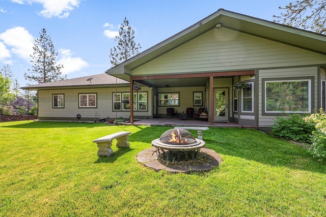 5959 Hayes Creek Rd, Missoula, MT 59804 - back of property with a fire pit, a patio, and a lawn