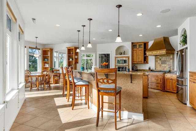 5959 Hayes Creek Rd, Missoula, MT 59804 - kitchen featuring custom range hood, appliances with stainless steel finishes, recessed lighting, plenty of natural light, and a kitchen breakfast bar