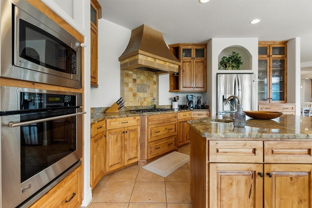 5959 Hayes Creek Rd, Missoula, MT 59804 - kitchen with appliances with stainless steel finishes, custom range hood, backsplash, dark stone countertops, and recessed lighting