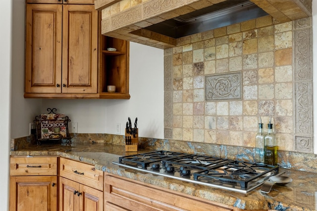 5959 Hayes Creek Rd, Missoula, MT 59804 - kitchen with stainless steel gas stovetop, custom range hood, brown cabinets, backsplash, and open shelves