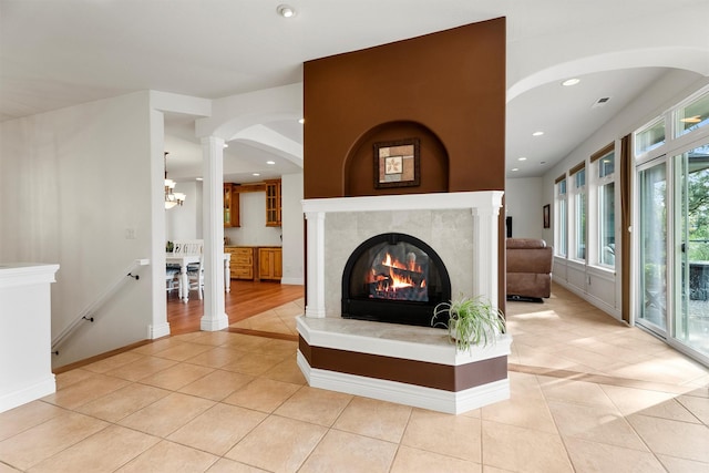 5959 Hayes Creek Rd, Missoula, MT 59804 - unfurnished living room with light tile patterned floors, a tile fireplace, recessed lighting, decorative columns, and baseboards