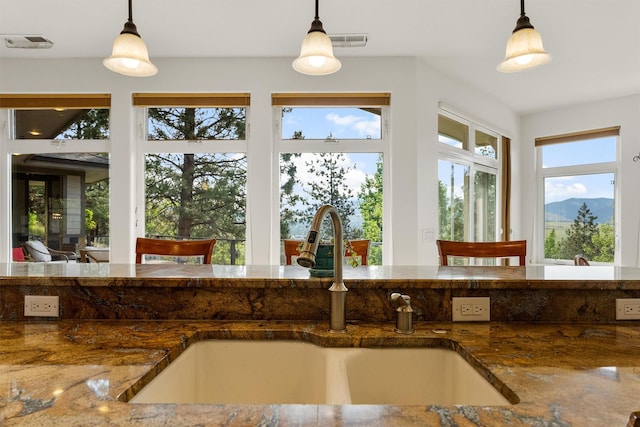 5959 Hayes Creek Rd, Missoula, MT 59804 - kitchen with a sink, pendant lighting, and dark stone countertops