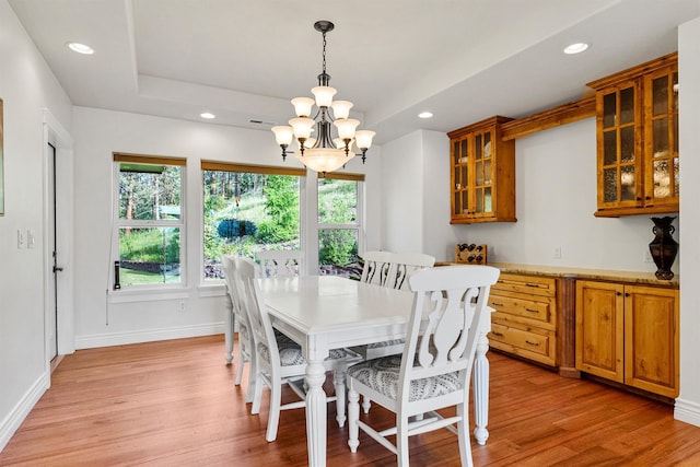 5959 Hayes Creek Rd, Missoula, MT 59804 - dining space featuring a chandelier, recessed lighting, light wood-style flooring, a raised ceiling, and baseboards