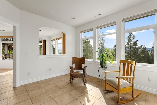 5959 Hayes Creek Rd, Missoula, MT 59804 - living area with light tile patterned floors, arched walkways, baseboards, and recessed lighting