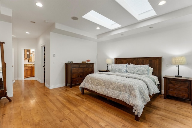 5959 Hayes Creek Rd, Missoula, MT 59804 - bedroom featuring a skylight, light wood-style floors, recessed lighting, and baseboards
