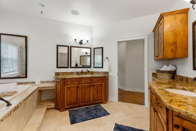 5959 Hayes Creek Rd, Missoula, MT 59804 - bathroom featuring two vanities, a garden tub, a chandelier, and tile patterned floors