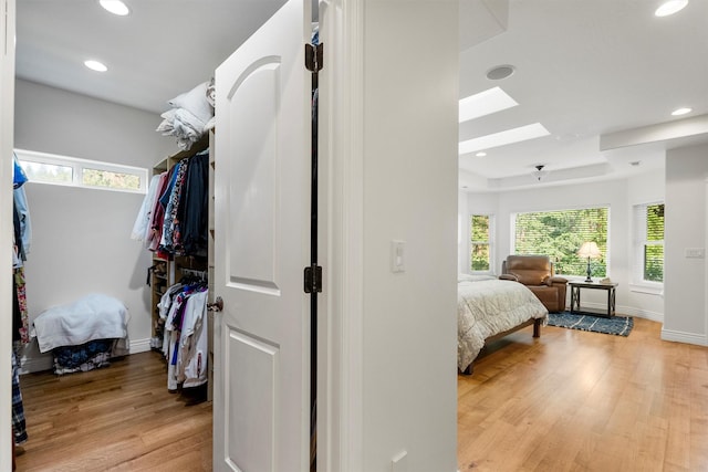 5959 Hayes Creek Rd, Missoula, MT 59804 - bedroom featuring a skylight, light wood-type flooring, multiple windows, recessed lighting, and baseboards